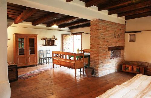a living room with a brick fireplace and a table at La Hansi in Crit in Criţ