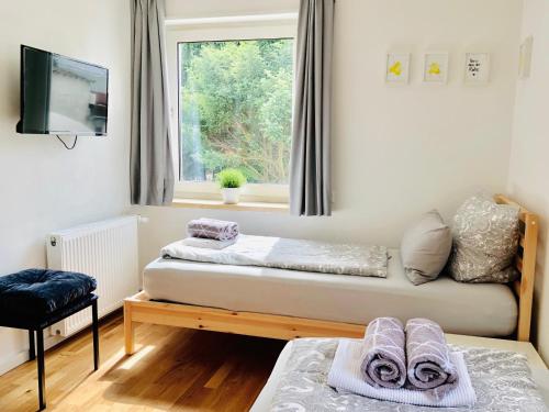 a room with two beds and a window at urbanAPARTMENT No.2 Memmingen in Memmingen