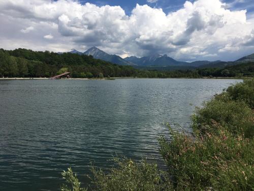 a large body of water with mountains in the background at Maison L'Aiguille - 2 appartements, 5 chambres et table d'hôtes au pied de la montagne à la station de Laye in Laye