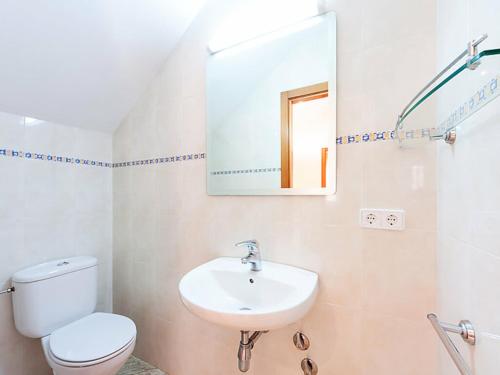 a bathroom with a sink and a toilet and a mirror at SANT BRIU in L'Escala