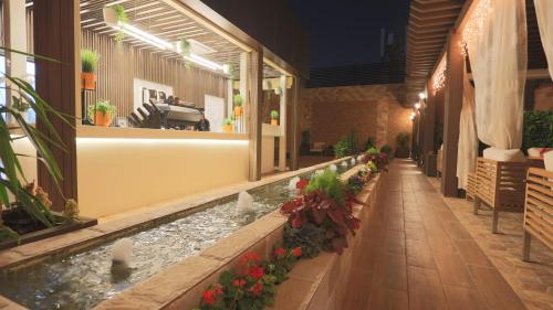 a building with a pond in the middle of a courtyard at Broad Almkan Apart Hotel in Taif