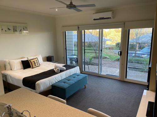 a bedroom with a bed and a sliding glass door at H Boutique Hotel in Pokolbin
