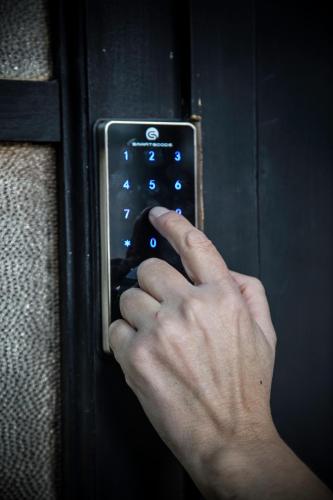 a person is unlocking a door with their hand at HOSTAL BOUTIQUE TERRA ANTARCTICA in Punta Arenas