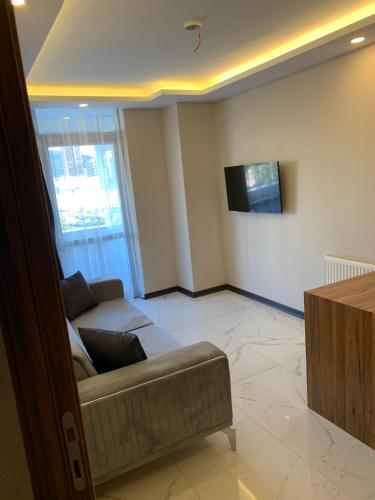 a living room with a couch and a tv at Royal Residence Bursa in Bursa