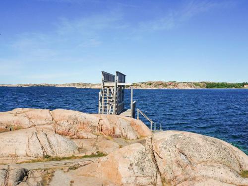a ladder on the side of some rocks in the water at 4 person holiday home in Bovallstrand-By Traum in Bovallstrand
