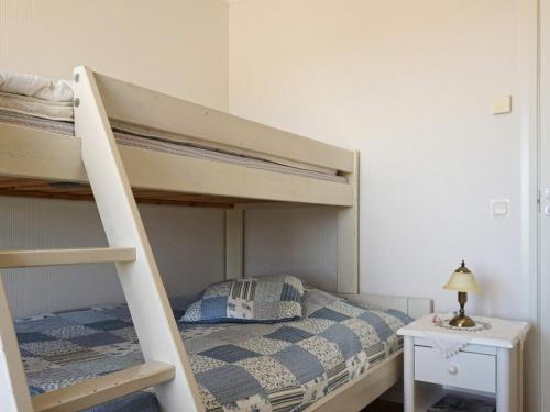 a bedroom with a bunk bed with a ladder at Holiday home Bovallstrand V in Bovallstrand