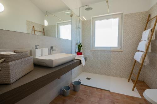 a bathroom with a sink and a mirror at Ares do Monte - Turismo Rural in Cercal