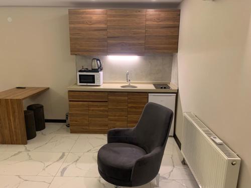 a small kitchen with a chair and a sink at Royal Residence Bursa in Bursa
