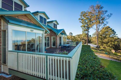a house with a white fence and a porch at Whale Cove Circuit in Eden