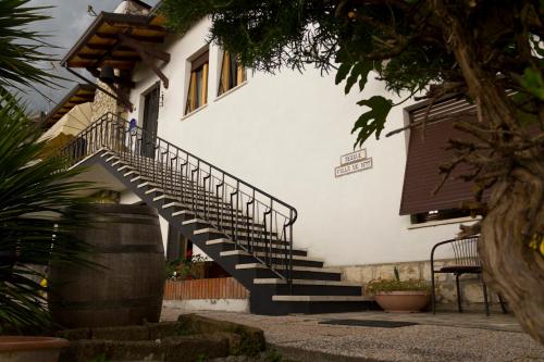 a house with a staircase in front of it at Villa de Ros in Salò