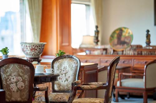 a dining room with chairs and a table and a table and chairs at The Howard Plaza Hotel Taipei in Taipei
