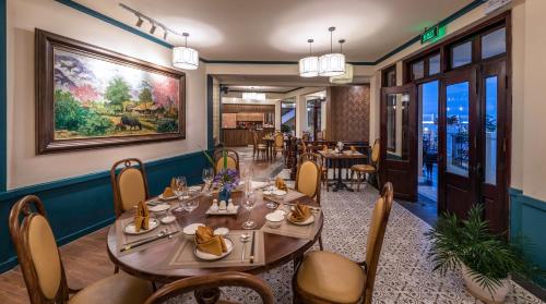 a restaurant with tables and chairs and a painting on the wall at Cat Cat Galerie d’Art in Sa Pa