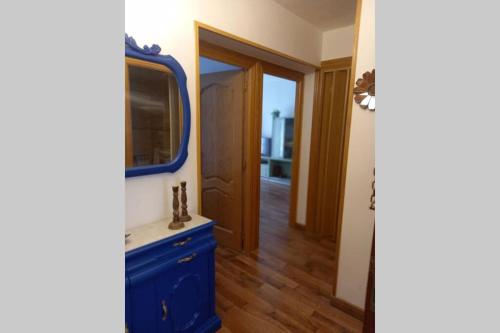 a bathroom with a blue sink and a mirror at La Casuca de Ana&Isabel in Palencia