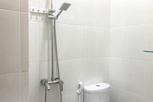 a shower in a bathroom with a toilet at RedDoorz near Sleman City Hall Yogyakarta in Yogyakarta