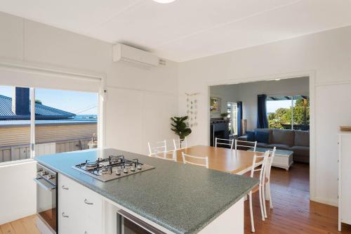 a kitchen and living room with a table and a counter top at Bungo Beach house - Pet Friendly home in Eden