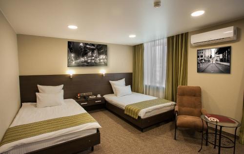 A bed or beds in a room at Hotel Khakasia