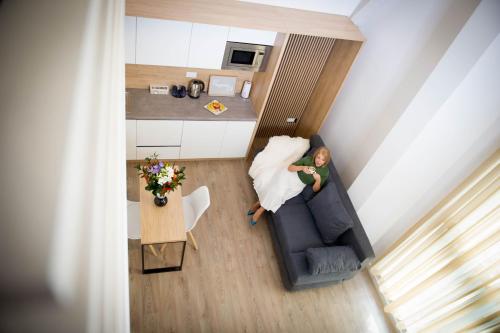 a woman in a wedding dress sitting on a couch at FRIENDS RESIDENCE Apartments in Timişoara