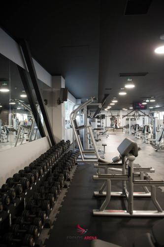 a gym with rows of treadmills and machines at FRIENDS RESIDENCE Apartments in Timişoara
