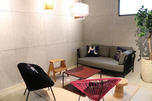 a living room with a couch and a table at Hotel The M's Kyoto in Kyoto