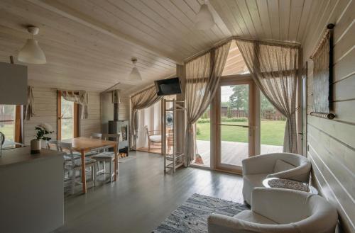 a kitchen and living room with a table and chairs at Talitsy Lodge in Talitsa