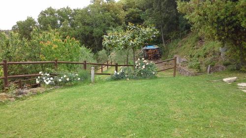 a wooden fence in a yard with flowers at Casa Crevole in Palazzina