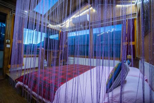 a bedroom with a bed in a cage at Shangri-La King Gesar Guesthouse in Shangri-La