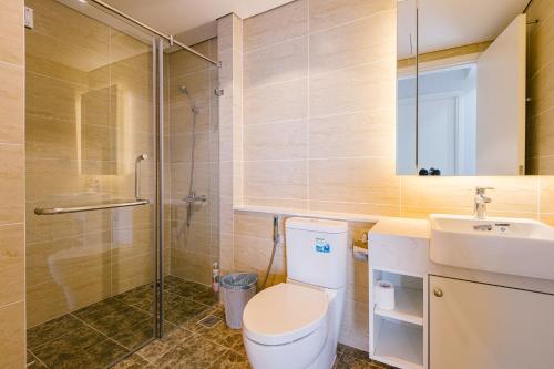 a bathroom with a toilet and a sink and a shower at 22Housing Vinhomes D'Capitale Hotel & Residence in Hanoi