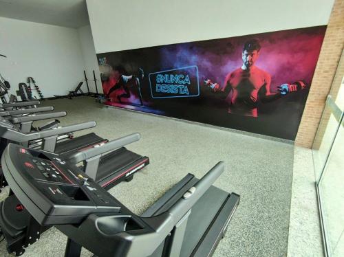 a gym with several treadmills and a large screen at Porto de Galinhas | Muro Alto 116B in Porto De Galinhas