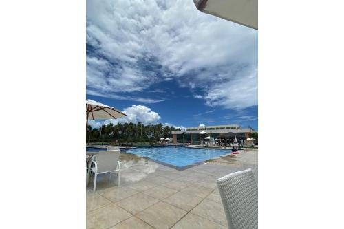 a view of a swimming pool with a cloudy sky at Porto de Galinhas | Muro Alto 116B in Porto De Galinhas