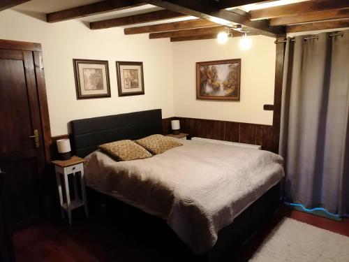a bedroom with a large bed in a room at Ranch pod lesom Slovensky Raj in Spišský Štiavnik