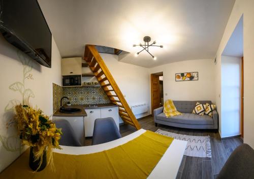 a living room with a spiral staircase and a couch at Edelin Wine House in Edelény