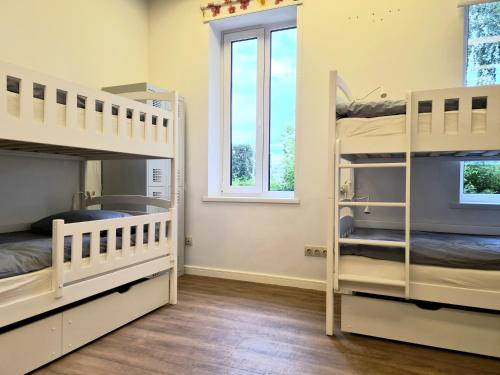 two bunk beds in a room with a window at RailWay Bed HOSTEL in Kaunas