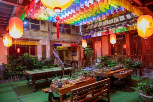 a restaurant with tables and a pool table at Shangri-La King Gesar Guesthouse in Shangri-La