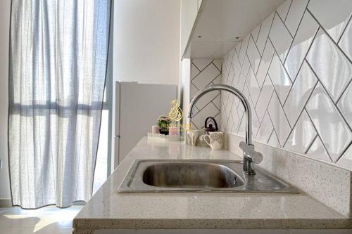 a kitchen counter with a sink in a kitchen at Dania 3 Midtown - AL Maraseem in Dubai