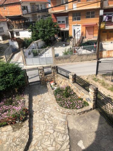 an overhead view of a courtyard with flowers and a fence at Centre apartment in Prilep