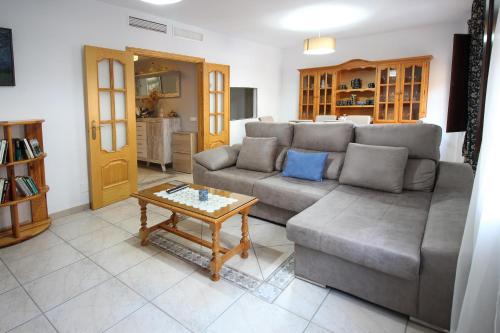 a living room with a couch and a coffee table at Casa sol in Vélez-Málaga