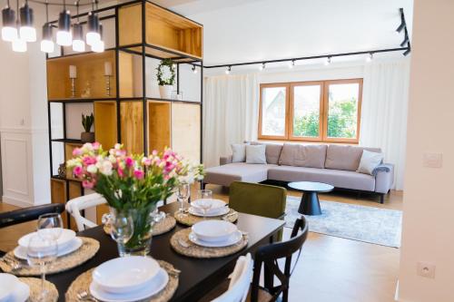 a living room with a table with flowers on it at Gdańska 24 in Giżycko