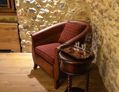 a brown chair with a tray of food on a table at Archontiko Chioti in Leonidion