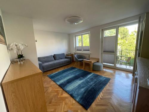 a living room with a couch and a blue rug at Apartament Basia in Gdynia