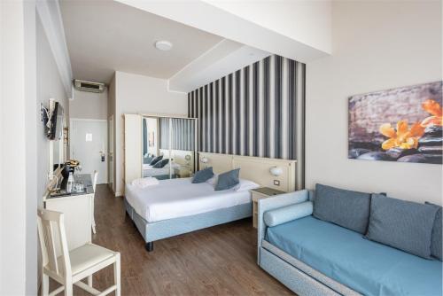 a living room with a couch and a bed at Hotel Splendid Palace in Limone sul Garda