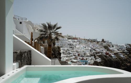 a bath tub with a view of a city at Stella Rocca A Mare in Imerovigli