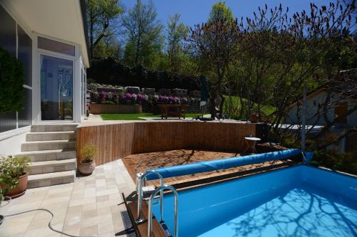 a swimming pool in the backyard of a house at Jeans Apartment in Horjul