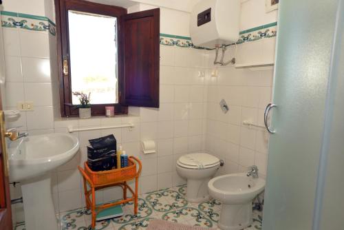 a bathroom with a toilet and a sink at I Dammusi Sapori di Pantelleria in Pantelleria