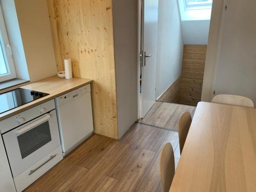 a kitchen with a counter top and a table at Book-A-Room Salzburg Apartment 5-6-7-8 in Salzburg