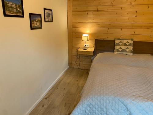 a bedroom with a bed and a lamp on a table at Book-A-Room Salzburg Apartment 5-6-7-8 in Salzburg