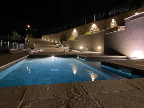 a swimming pool in a yard at night at Il Castello Di Perchia in Crocemaroggia