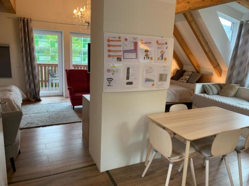 a kitchen and living room with a table and a refrigerator at Book-A-Room Salzburg Apartment 5-6-7-8 in Salzburg