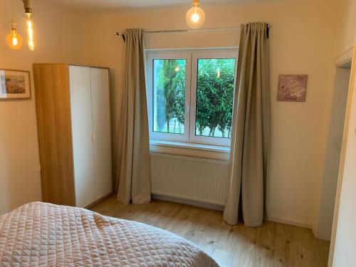 a bedroom with a bed and a window at Book-A-Room Salzburg Apartment 5-6-7-8 in Salzburg