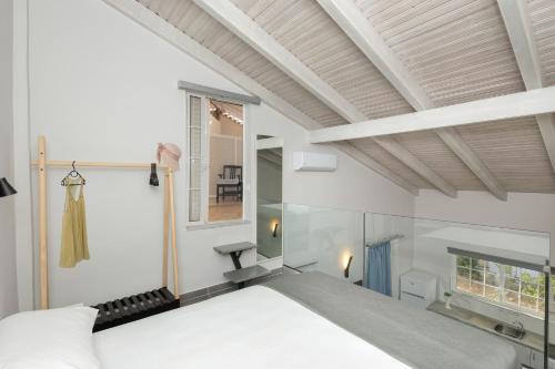 a bedroom with a bed and a window at El Greco Studios in Agia Marina Nea Kydonias