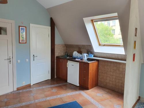 a small kitchen with a sink and a window at Avanta in Liepāja